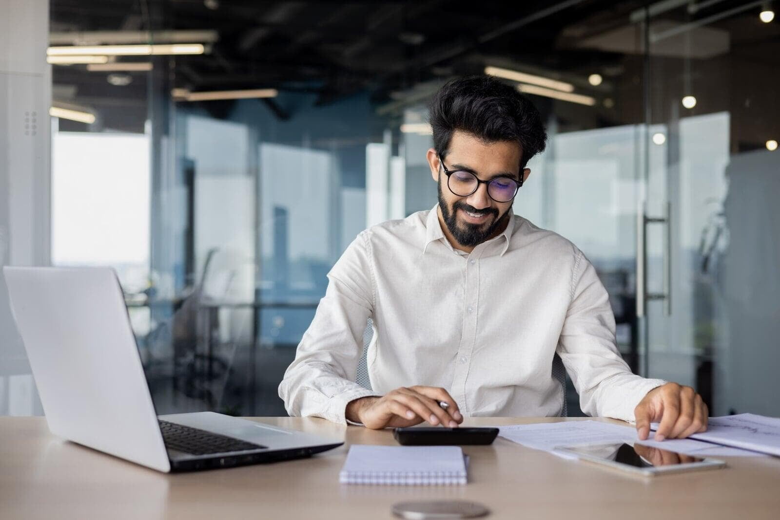 Accountant at desk calculating yearly tax return